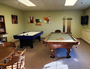 Air hockey table and billiards table in SRC game room.